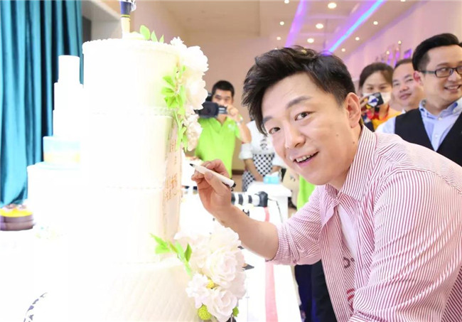 黄渤在三十周年庆典主题蛋糕上签名，祝福新东方烹饪